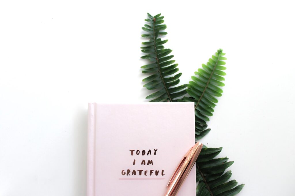 A journal with headline "Today I Am Grateful" and pen on white table.

Writing journals is an excellent way to practice gratitude.