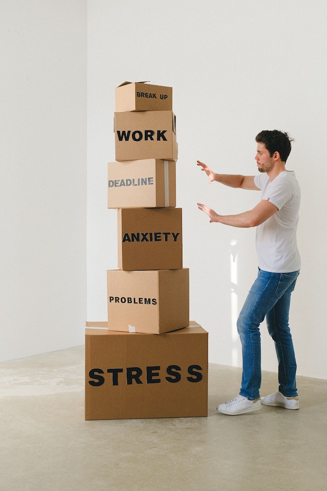 man-near-carton-boxes-with-many-different-words-about-stress Problem Solving skills is very important for project managers and life in general.